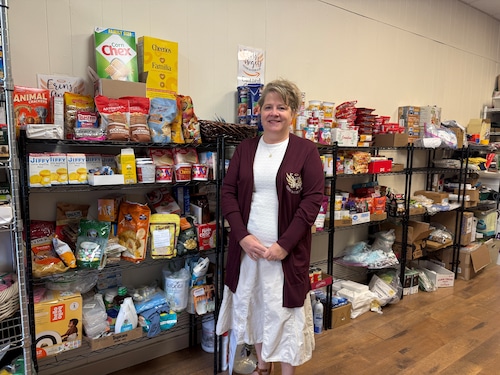 Sheila Dion stands in Erin's Angels storefront in Phoenix. The nonprofit announces on Facebook when families can pick up food, cleaning supplies and toiletries. The address is 219 County Route 57.