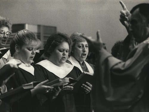 Members of the St. Mary's Church choir are directed by James DeLuca in 1985.