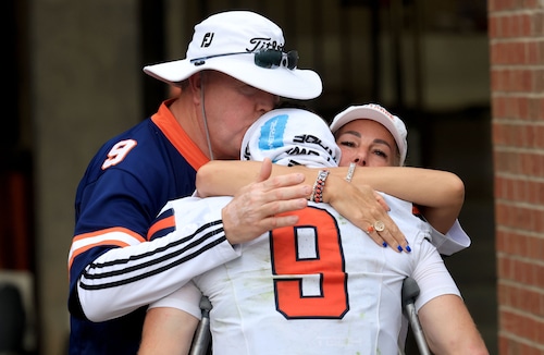 Syracuse football quarterback Steve Angeli is met by his parents Stefanie and Janos. After Angelli was helped off the field with an achilles injury. The Syracuse Orange travel to Memorial Stadium to play Clemson in South Carolina Sep. 20, 2025. . Dennis Nett | dnett@syracuse.com