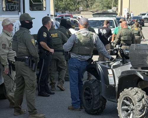 Federal agents and Cayuga County deputies at an immigration raid at the Nutrition Bar Confectioners plant in Cato on Thursday, Sept. 4, 2025.