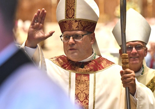 The newly ordainded Bishop Rev. Douglas Lucia walks by the audience to give his blessing. The ordination of Rev. Douglas John Lucia as the Bishop of the Roman Catholic Diocese of Syracuse at The Cathedral of the Immaculate Conception, August 8, 2019.
