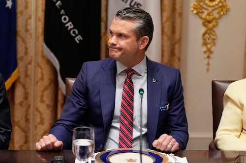 Defense Secretary Pete Hegseth listens as a reporter asks a question during a meeting with President Donald Trump and Argentina's President Javier Milei in the Cabinet Room of the White House, Tuesday, Oct. 14, 2025, in Washington. (AP Photo/Alex Brandon)