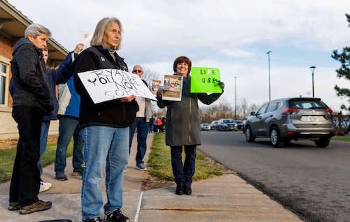 Gloria Keeler and Cindy Ciecierski hold up signs against The Onondaga County Industrial Development Agency's eminent domain attempt against 91-year-old widow Azalia King from her home to make way for Micron Technology. More than 150 people packed the Clay Town Hall Thursday, November 20, 2025 to fight back against Onondaga County’s efforts to evic (N.t  Scott Trimble | strimble@syracuse.com)