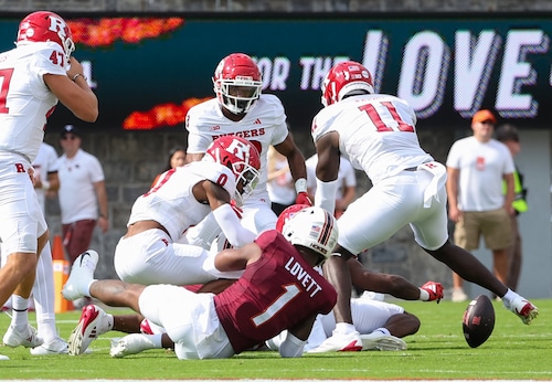Rutgers coverage team dives on a loose ball after Virginia Tech return man Dante Lovett (1) fumbled the ball away during the first quarter, Saturday, Sept. 21 2024, in Blacksburg, Va. 