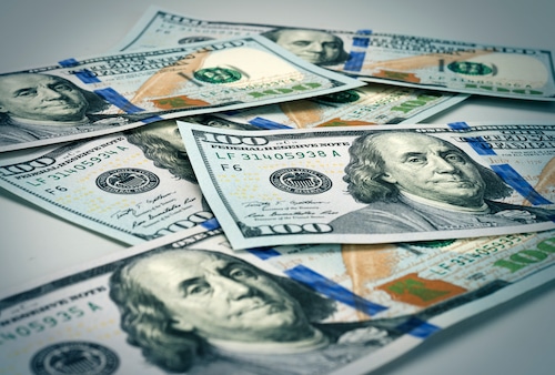 U.S. $100 bills piled up