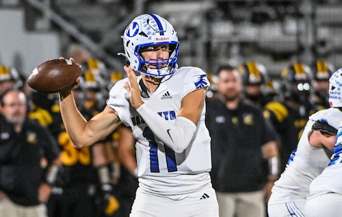 Nazareth QB Peyton Falzone (11) brings the ball back to pass against Freedom, Sept. 12, 2025.