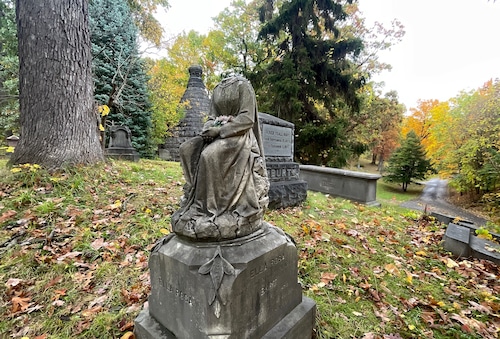 The monument of Ella Rosa Burt at Syracuse's Oakwood Cemetery is missing its head. She died of typhoid fever in 1872 at just 19 years old.