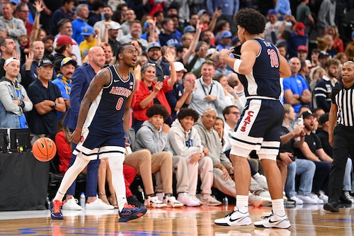 INGLEWOOD, CA - NOVEMBER 14: Arizona Wildcats guard Jaden Bradley (0) celebrates with Arizona Wildcats forward Koa Peat (10) after the Hall of Fame Series Los Angeles, a men's college basketball game between Arizona Wildcats vs. UCLA Bruins on November 14, 2025 at Intuit Dome in Los Angeles, California. (Photo by Brian Rothmuller/Icon Sportswire via Getty Images)
