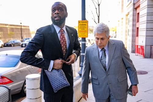FILE - Prakazrel "Pras" Michel, a member of the 1990s hip-hop group the Fugees, accompanied by defense lawyer David Kenner, right, arrives at federal court April 3, 2023, in Washington. (AP Photo/Andrew Harnik, File)