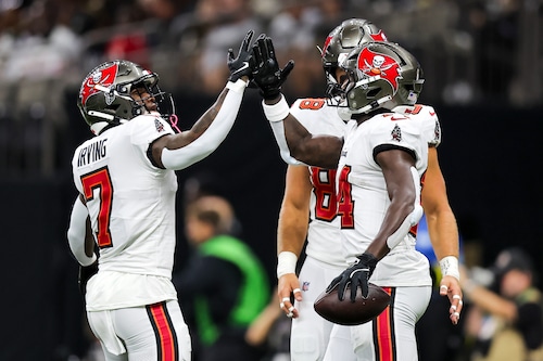 NEW ORLEANS, LOUISIANA - OCTOBER 13: Chris Godwin #14 of the Tampa Bay Buccaneers (L)  celebrates with teammate Bucky Irving #7 (R) after scoring a touchdown against the New Orleans Saints during the first quarter of the game at Caesars Superdome on October 13, 2024 in New Orleans, Louisiana. (Photo by Jonathan Bachman/Getty Images)