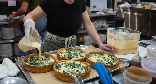 A chef works in a restaurant kitchen.