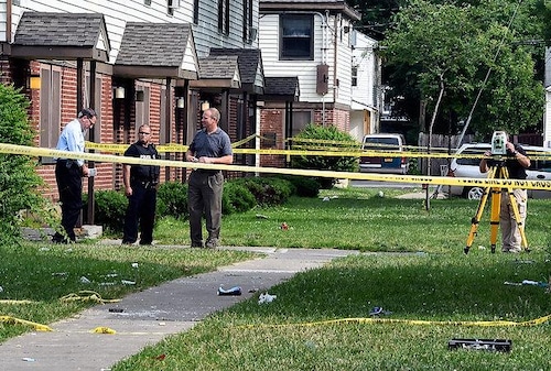 Syracuse police officers on Tully Street between Tioga and Wyoming Streets, Monday, June 20, 2016, after an officer-involved shooting Sunday night.