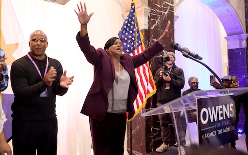 Sharons Owens greets her supporters as her husband, Shaun, applauds after she won the Syracuse mayoral race Tuesday, Nov. 4, 2025. Her campaign's watch party was held at The Treasury in the city's downtown.  (Dennis Nett | dnett@syracuse.com)