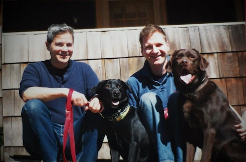 Rick Reina and his husband Jeremy Dottin-Reina with their dogs Max and Louis at their old home on Fellows Avenue, in Syracuse.