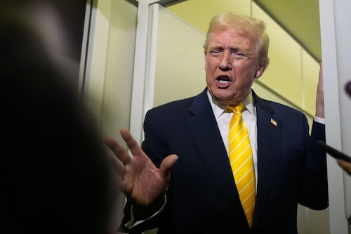 President Donald Trump speaks to reporters on Air Force One