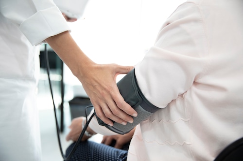 A woman has her blood pressure taken