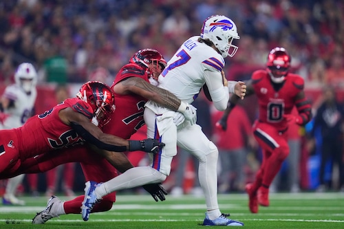 Houston Texans' Danielle Hunter, left, and Tommy Togiai, center, sack Buffalo Bills quarterback Josh Allen (17) in the second half of an NFL football game Thursday, Nov. 20, 2025, in Houston. (AP Photo/Ashley Landis)